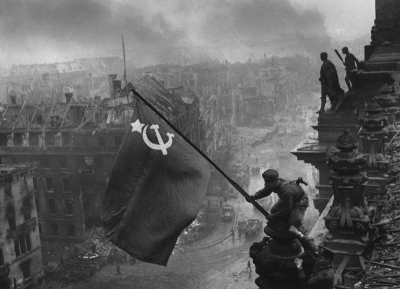Raising a flag over the Reichstag, by Yevgeny Khaldei